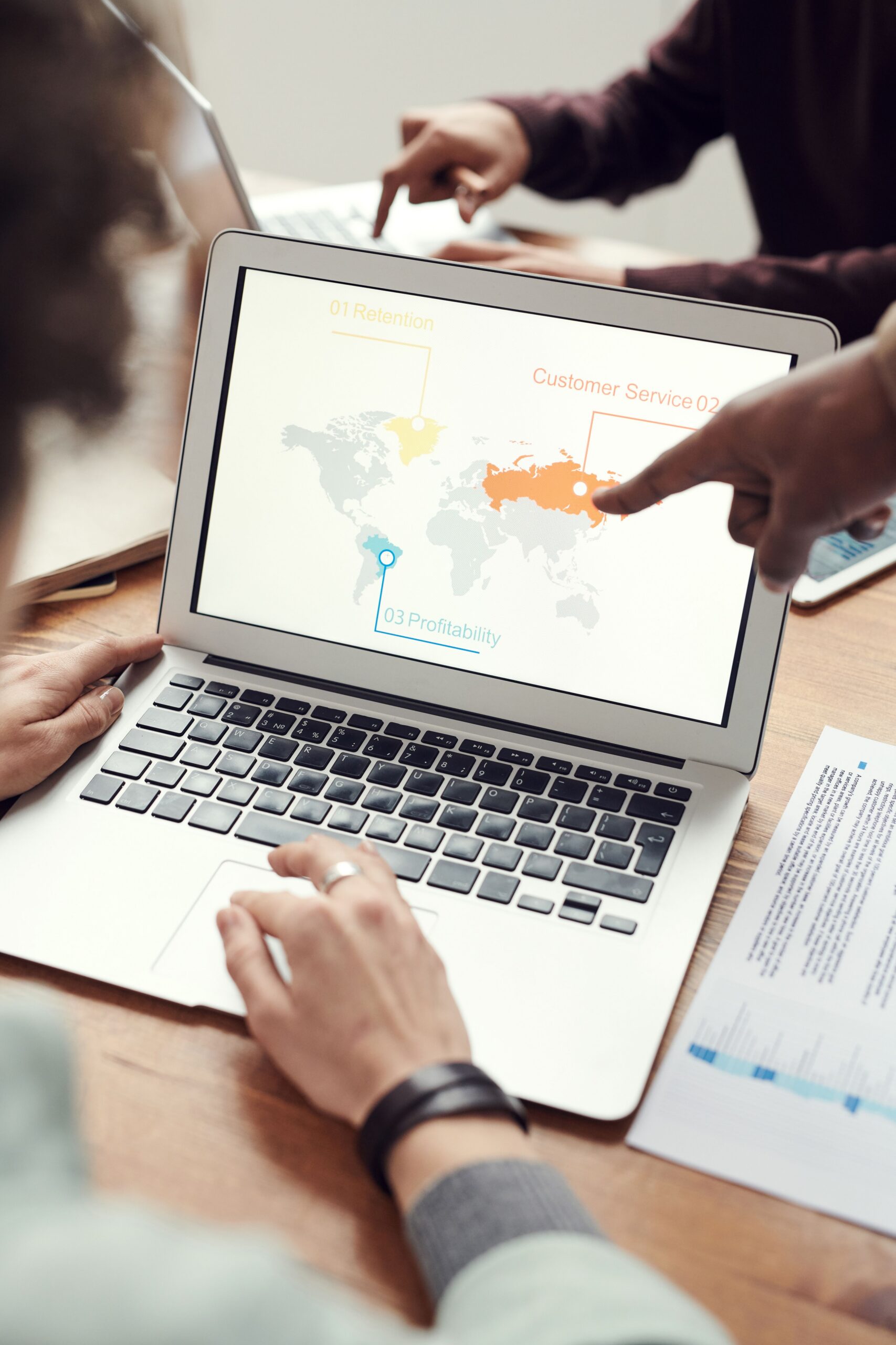 AI Advertising: 7 Powerful Updates Marketers Can Use Now 2 Colleagues reviewing AI advertising results from Meta and Google campaigns on a laptop